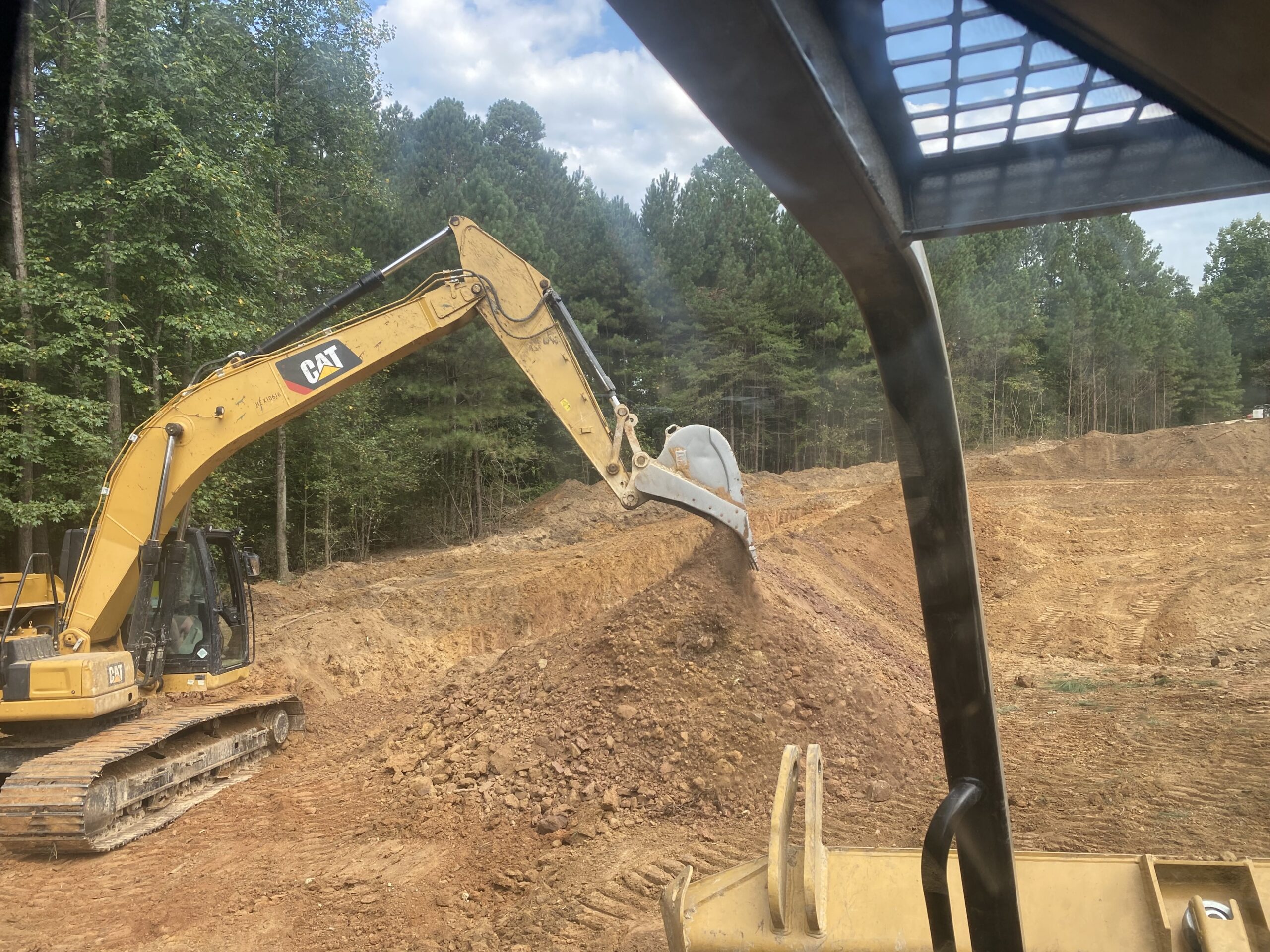 Excavator digging a trench in Adairsville GA.